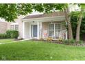 Lovely front porch with rocking chairs, decorative pillows, and lush garden beds at 15409 Heath Cir, Westfield, IN 46074