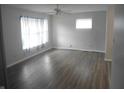 Bright living room featuring hardwood floors, ceiling fan and ample natural light at 1732 N Ritter Ave, Indianapolis, IN 46218