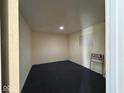 A look inside to an empty room with gray carpet and a lit light on the ceiling, and a 'For Rent' sign in the corner at 1920 Kildare Ave, Indianapolis, IN 46218