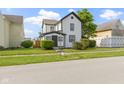 Charming home featuring a white exterior with black trim and a well-manicured lawn at 2111 S A St, Elwood, IN 46036