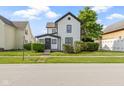 Charming home featuring a white exterior with black trim and a well-manicured lawn at 2111 S A St, Elwood, IN 46036