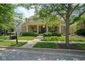 Attractive exterior showcasing landscaped yard, brick facade, and covered front porch at 2223 Shaftesbury Rd, Carmel, IN 46032