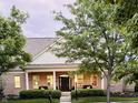 Attractive home showcasing a covered front porch and well-maintained landscaping at 2223 Shaftesbury Rd, Carmel, IN 46032