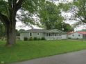 Attractive single-story house with a well-manicured lawn and mature trees at 229 Arnold St, Morgantown, IN 46160