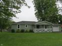 Quaint single-story home with a lovely front yard and attached garage at 229 Arnold St, Morgantown, IN 46160