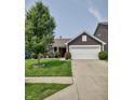 Traditional home featuring a manicured lawn and a two-car garage, complemented by landscaping at 2432 Bridlewood Dr, Franklin, IN 46131