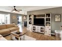 Comfortable living room with a sectional couch, custom media center, and stylish decor at 2538 Bridlewood Dr, Franklin, IN 46131