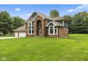 A picturesque two-story home with a lush green lawn and well-manicured landscaping at 2871 Mullinix Rd, Greenwood, IN 46143