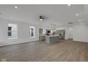 Bright, open-concept living room and kitchen with stainless steel appliances and hardwood floors at 2903 Winthrop Ave, Indianapolis, IN 46205