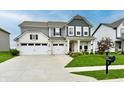 Charming two-story home with landscaped yard, three-car garage, and inviting curb appeal at 3872 New Battle Ln, Bargersville, IN 46106