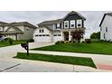 Home with well maintained lawn, cute landscaping, mailbox and three car garage on a cloudy day at 3872 New Battle Ln, Bargersville, IN 46106
