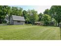 Large backyard showcasing a barn and shed, perfect for outdoor activities at 4124 Five Points Rd, Indianapolis, IN 46239