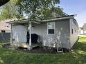 Back exterior view of home and covered back porch with nice landscaping at 420 S Oak St, Fortville, IN 46040