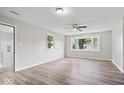 Bright bedroom with a ceiling fan, hardwood floors, and large window at 4255 N County Road 1025 E, Indianapolis, IN 46234