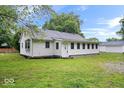 View of charming home with green lawn and white detached garage at 4255 N County Road 1025 E, Indianapolis, IN 46234