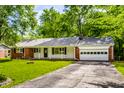 Charming single story brick home with attached garage, and a mature tree-lined lawn at 4275 Springwood Trl, Indianapolis, IN 46228