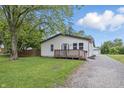 Inviting home with a front porch, driveway, and lovely landscaping enhancing its overall appeal at 450 N Fenton Ave, Indianapolis, IN 46219