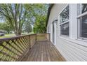 Inviting, covered porch with a wooden deck and railings, providing a relaxing outdoor space at 450 N Fenton Ave, Indianapolis, IN 46219