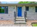 Inviting front entrance with a stylish blue door and stone accents at 4853 E 65Th St, Indianapolis, IN 46220