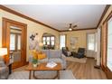 Bright and airy living room with hardwood floors, ceiling fan, and neutral paint colors at 5133 E Michigan St, Indianapolis, IN 46219