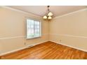 Dining room featuring hardwood floors, neutral walls, and large windows at 5153 Brendonshire Ct, Indianapolis, IN 46226