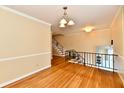 Bright foyer with hardwood floors, staircase and metal railing at 5153 Brendonshire Ct, Indianapolis, IN 46226