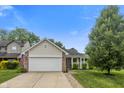 Attractive single-Gathering house with a well-manicured lawn and a cozy front porch at 5216 Lakeside Manor Blvd, Indianapolis, IN 46254