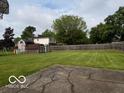 Spacious backyard featuring a large grassy area and a wood fence at 624 S High School Rd, Indianapolis, IN 46241
