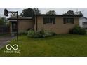 This home features a well-manicured lawn and charming brick exterior at 624 S High School Rd, Indianapolis, IN 46241