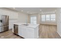 Bright kitchen with stainless steel appliances and a view into the sunny dining area at 7330 Shroyer Way, Noblesville, IN 46062