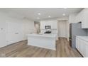 Well-lit kitchen with white cabinets, island, and stainless steel appliances at 7330 Shroyer Way, Noblesville, IN 46062