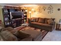 Cozy living room with plush brown sectional, decorative accents, and ample natural light at 7402 Broadview Dr, Indianapolis, IN 46227