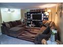 Inviting living room with comfortable brown sofas, stylish decor, and a large television at 7402 Broadview Dr, Indianapolis, IN 46227