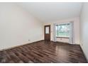 Bright living room with wood-look floors and a large window at 7418 Southern Lakes Dr, Indianapolis, IN 46237