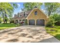 Charming two-story home with a stone-accented facade and a three-car garage at 7630 Blain Way, Indianapolis, IN 46254