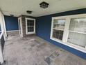Covered porch with a slate tile floor and white columns offering a cozy outdoor living space at 802 Fern Dr, Shelbyville, IN 46176