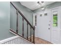 The home's entryway features tile floors, a staircase, and a white door with glass panes at 8205 Picadilly Ln, Indianapolis, IN 46256