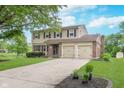 Charming two-story house with a spacious driveway, two-car garage, and lush front lawn at 8205 Picadilly Ln, Indianapolis, IN 46256