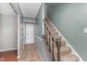 Carpeted staircase featuring white trim, muted green walls, and access to the upper level at 8205 Picadilly Ln, Indianapolis, IN 46256