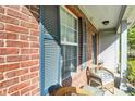 Inviting front porch with wicker chairs and blue shutters offering a relaxing outdoor space at 1024 Rotherham Ln, Beech Grove, IN 46107