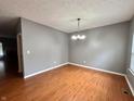 Bright dining room with wood floors and contemporary lighting at 10725 Tedder Lake Dr, Indianapolis, IN 46239