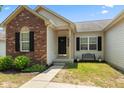 Charming single-Gathering home featuring a brick facade, well-maintained front yard, and covered entryway at 10725 Tedder Lake Dr, Indianapolis, IN 46239