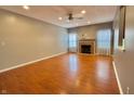 Open-concept living room featuring a fireplace and ceiling fan at 10725 Tedder Lake Dr, Indianapolis, IN 46239