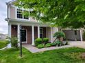 Front porch of a house, with brick columns and manicured landscaping at 11070 Long Lake Ln, Fishers, IN 46037