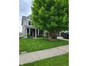 Charming home exterior featuring a well-manicured lawn and beautiful landscaping at 11070 Long Lake Ln, Fishers, IN 46037