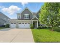 Charming two-story home featuring a three-car garage and well-maintained lawn at 1221 Hamilton Dr, Greenwood, IN 46143
