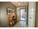 Welcoming foyer with a stylish console table, decorative lighting, and tiled floor at 131 Olde Mill Bay, Indianapolis, IN 46260