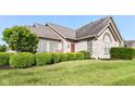Home's lush landscaping, a stone facade, and large windows, give it lots of curb appeal on a nice day at 13807 Rue Fontaine Ln, McCordsville, IN 46055