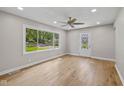 Bright living room featuring hardwood floors, a large window, and a decorative glass front door at 1382 S Morgantown Rd, Greenwood, IN 46143