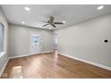 Spacious living room with hardwood floors, ceiling fan, recessed lighting and inviting front door at 1382 S Morgantown Rd, Greenwood, IN 46143